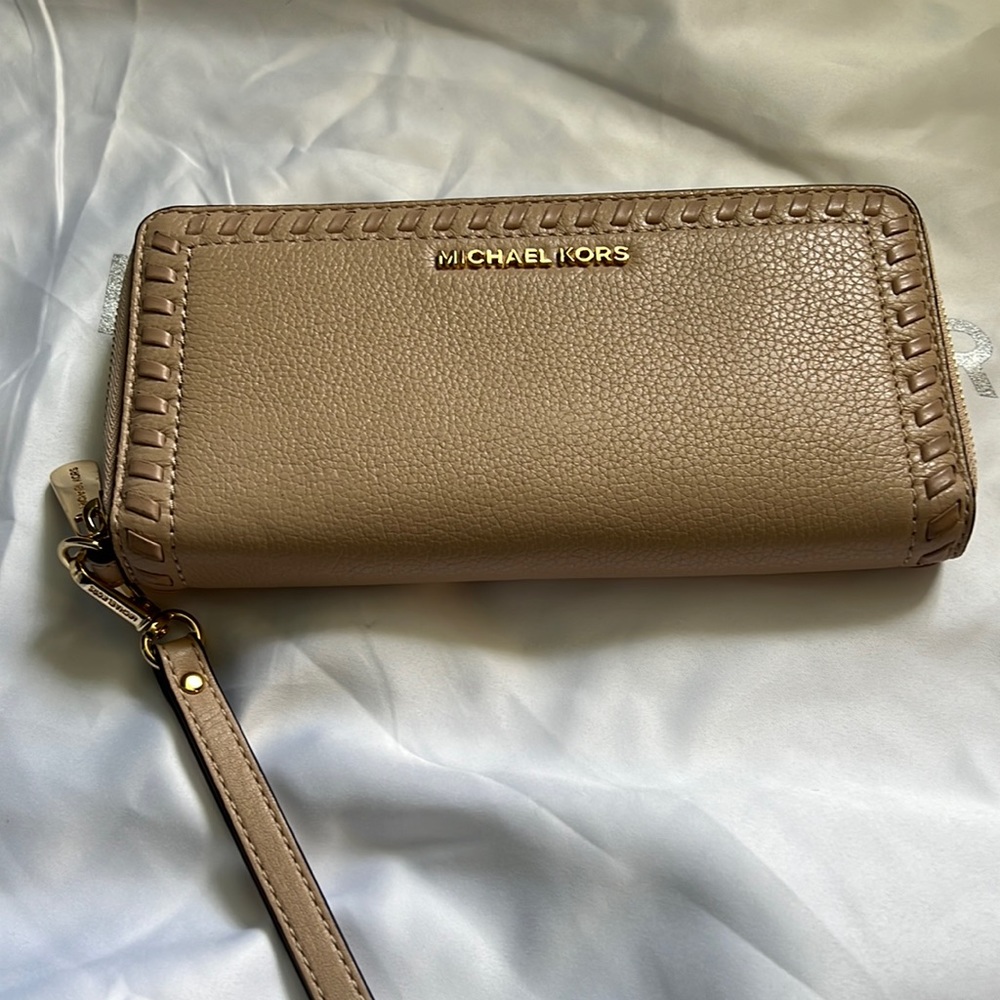 Authentic cream colored MK wristlet wallet.